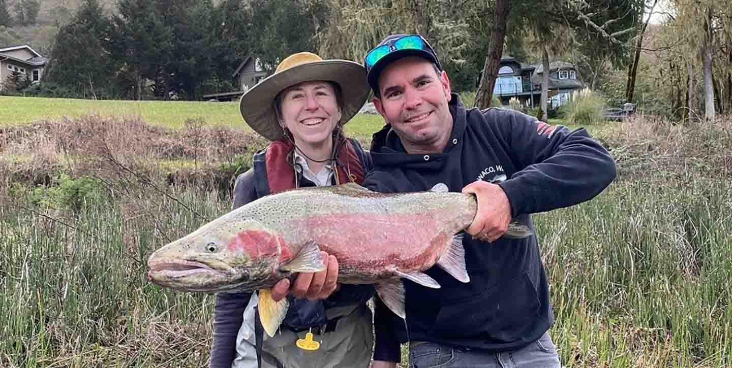 couple holding a large fish