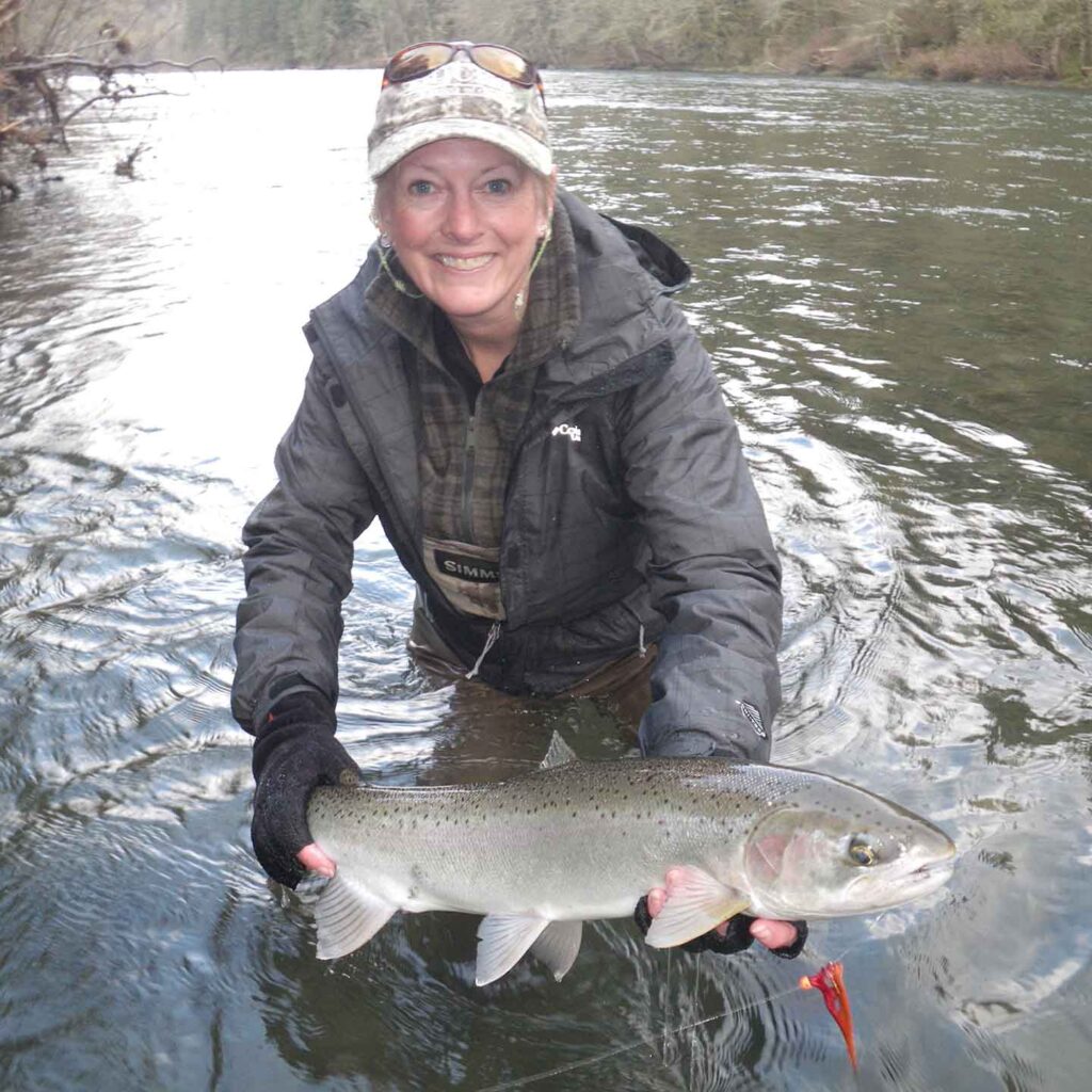 female flyfisher showing sandy fish catch