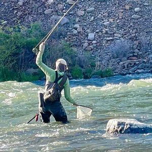 Woman landing redside trout