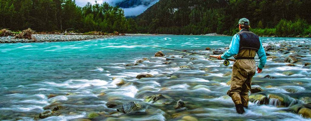 flyfisher wading out into stream - photo by David lambroughton