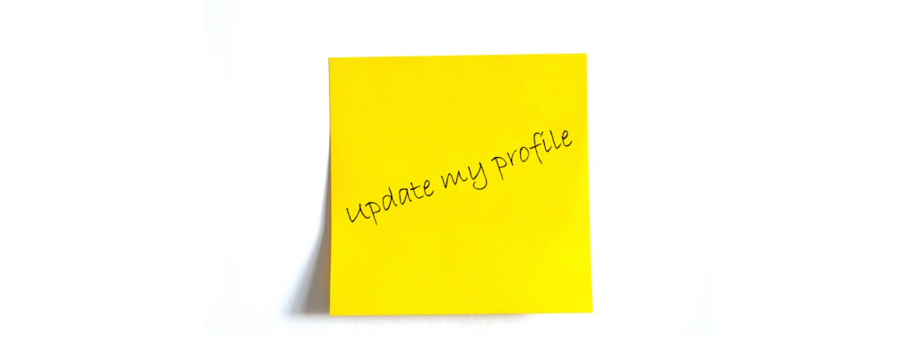 yellow sticky note with hand written message saying "update my profile"