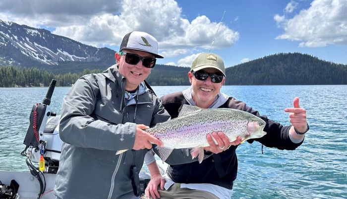 two flyfishers holding their catch