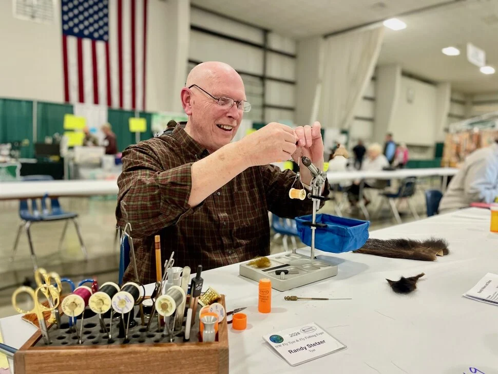 man teaching others about fly fishing