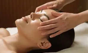 woman receiving a massage on her temples